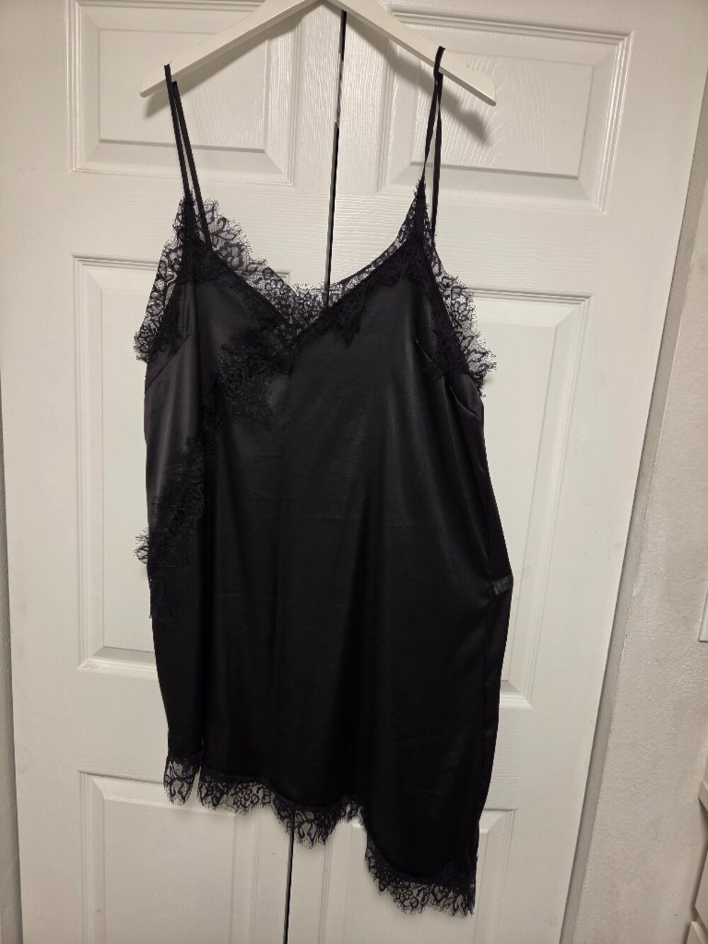 Black cami-solé with lace and asymmetrical hem.